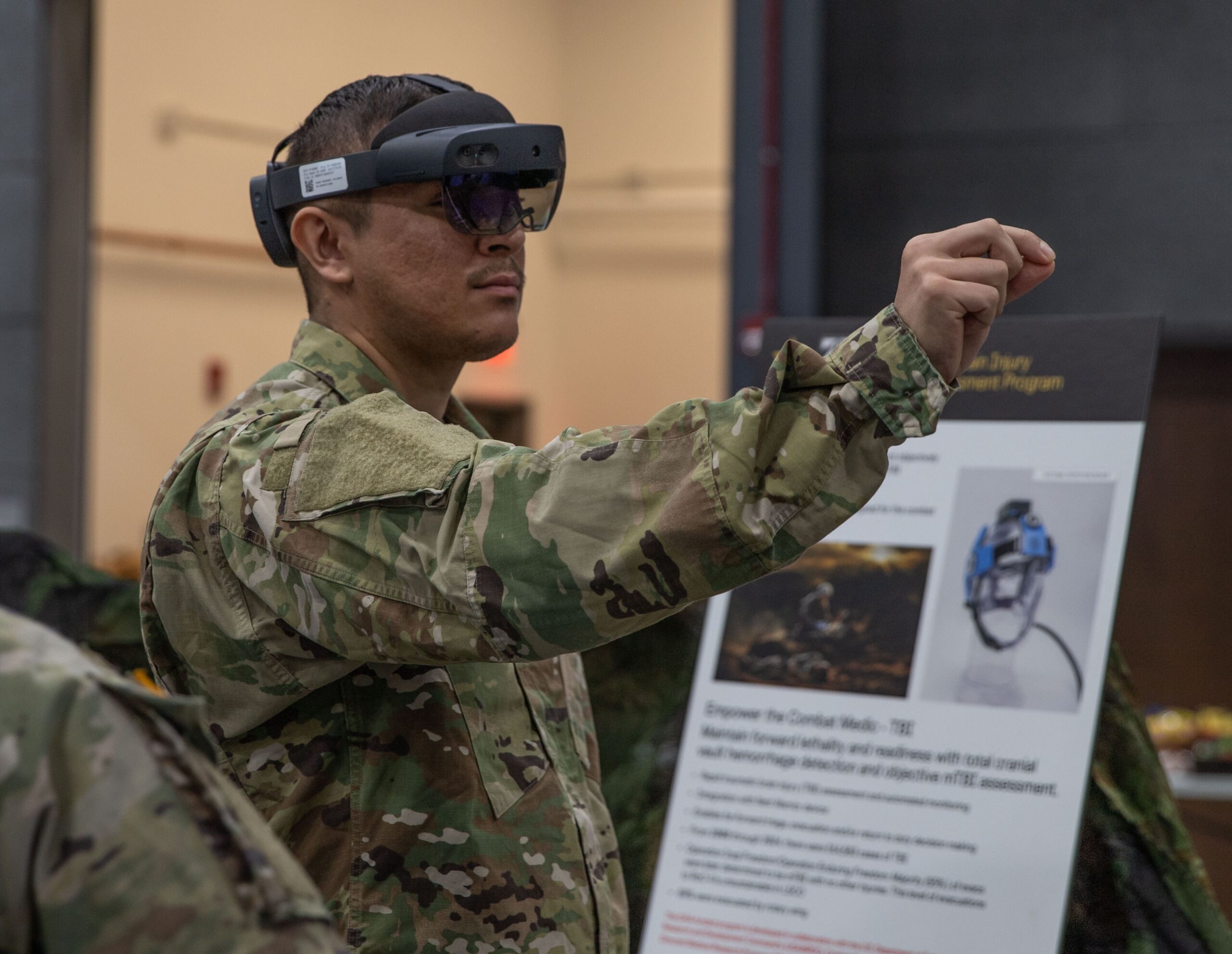 ROTC participants presenting research results at an Army research facility.